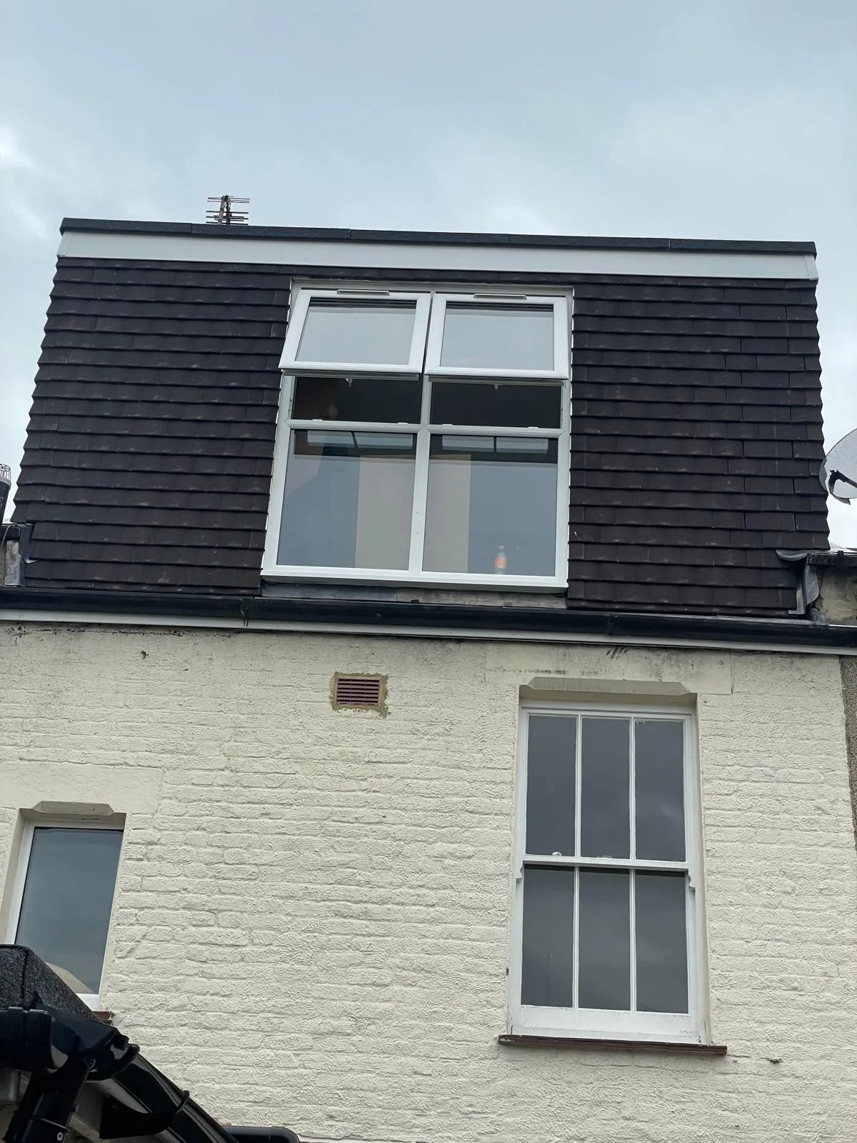 Mansard loft extension with white window