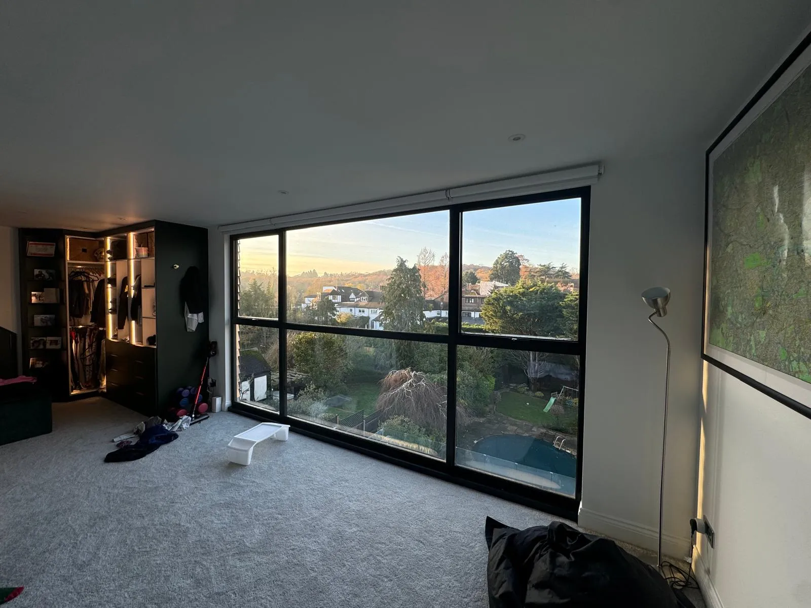 Modern bedroom with walk-in wardrobe and big window